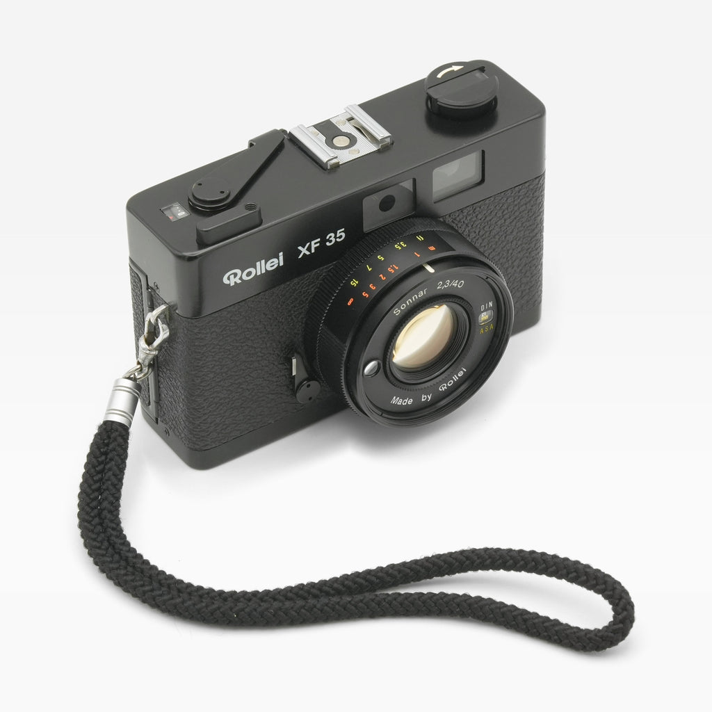 Rollei XF 35 35mm film camera, angled with wrist strap